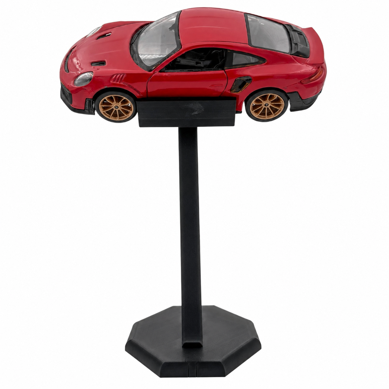 A red die-cast model sports car displayed on a black stand against a plain white background.