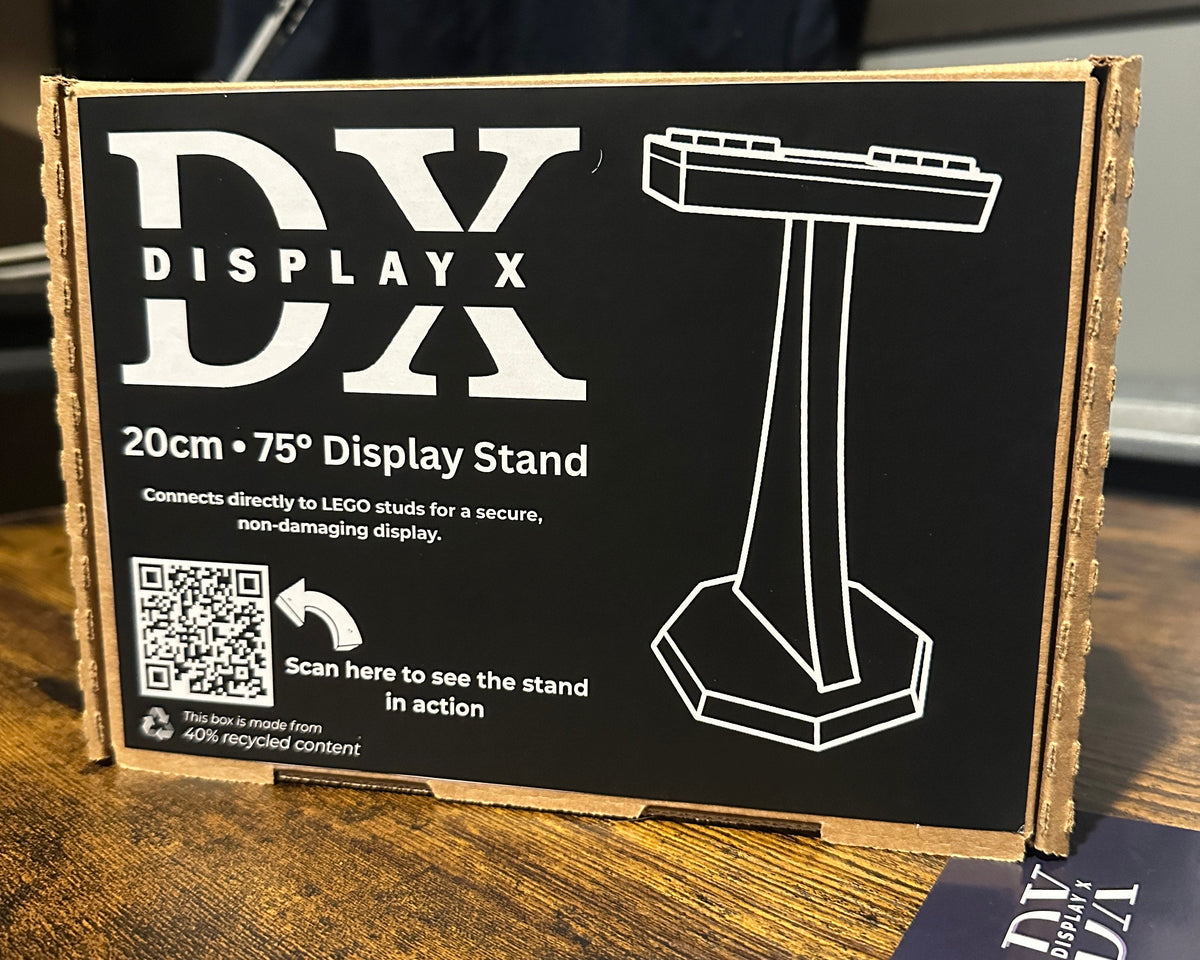 Display stand packaging with 'DX Display' branding on a wooden surface