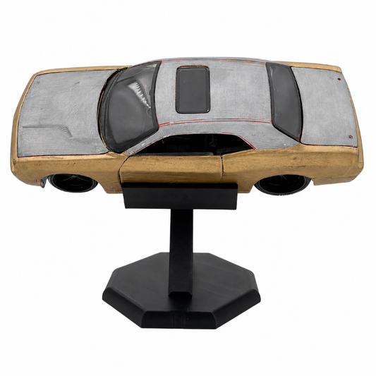 A scale model of a classic car with a silver-gray textured roof, a light wood-grained body, and a black stand, shown against a plain white background.